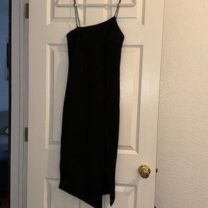 Beginning boutique black asymmetrical dress with slit